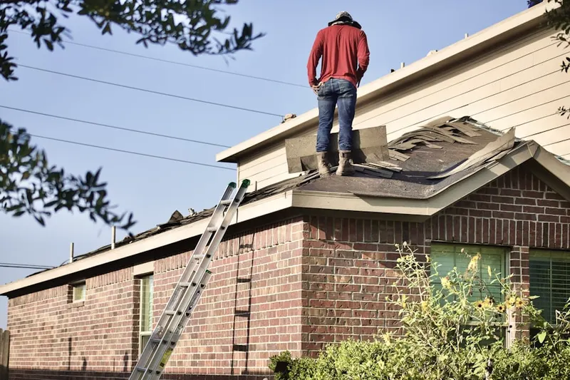 Professional roofer working on a residential roof in Street Road